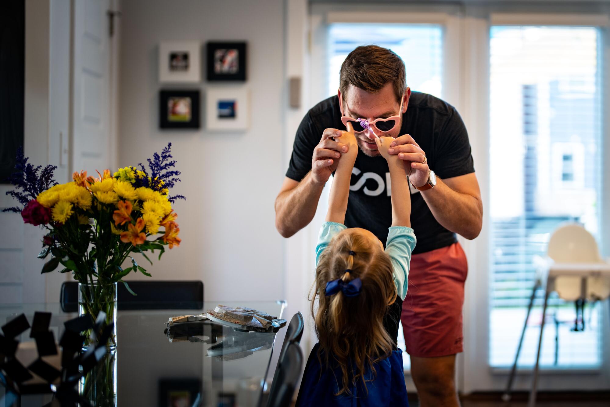 Rep. Eric Swalwell wears a pair of heart-shaped sunglasses while playing with his daughter, Kathryn, 3.