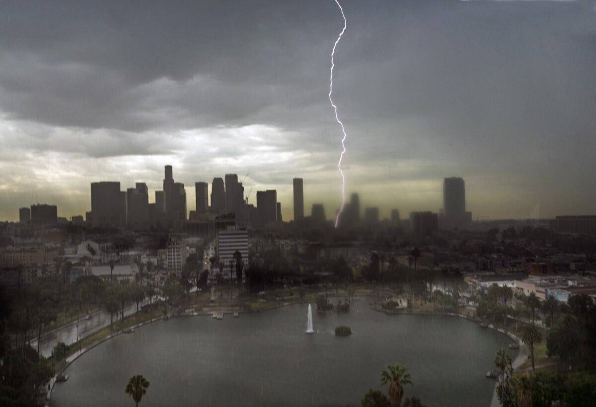 Lightning splits the sky in downtown Los Angeles early Saturday in this view from the American Cement Building overlooking MacArthur Park Lake.