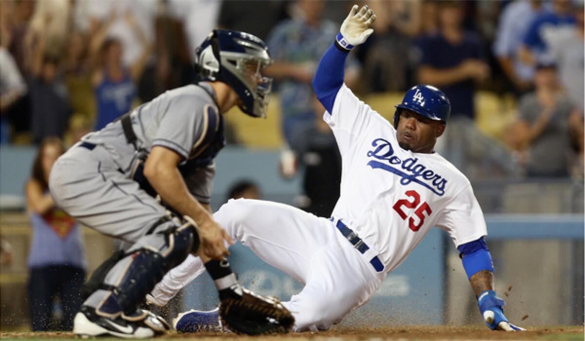Four-time American League stolen-base champion Carl Crawford, shown sliding safely past San Diego catcher Nick Hundley on Friday, has only 13 for the Dodgers this season.