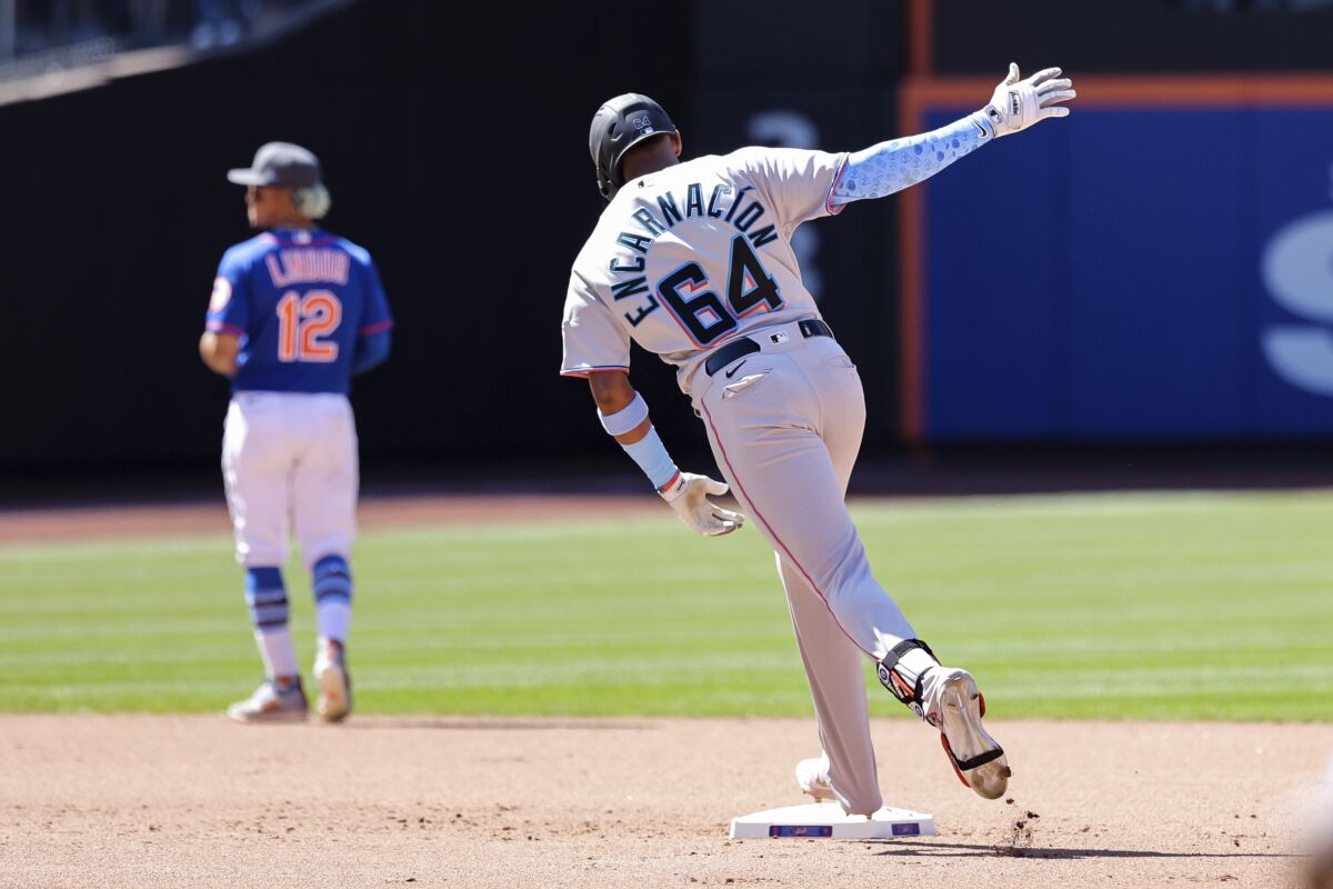 Miami Marlins' Jerar Encarnácion (64) reacts while rounding the bases after hitting a grand slam against New York Mets relief pitcher Seth Lugo during the seventh inning of a baseball game, Sunday, June 19, 2022, in New York. (AP Photo/Jessie Alcheh)