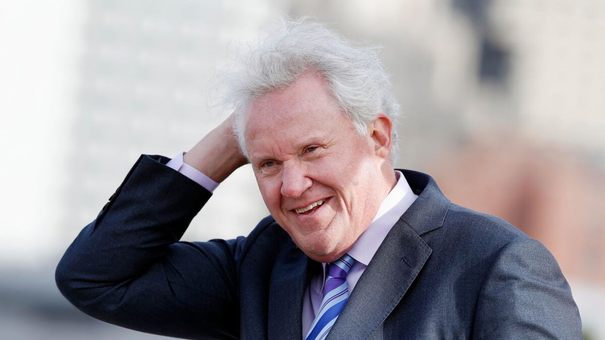 Why is this man laughing? Departing General Electric CEO Jeff Immelt braves the weather at a groundbreaking ceremony for GE's new Boston headquarters last month.