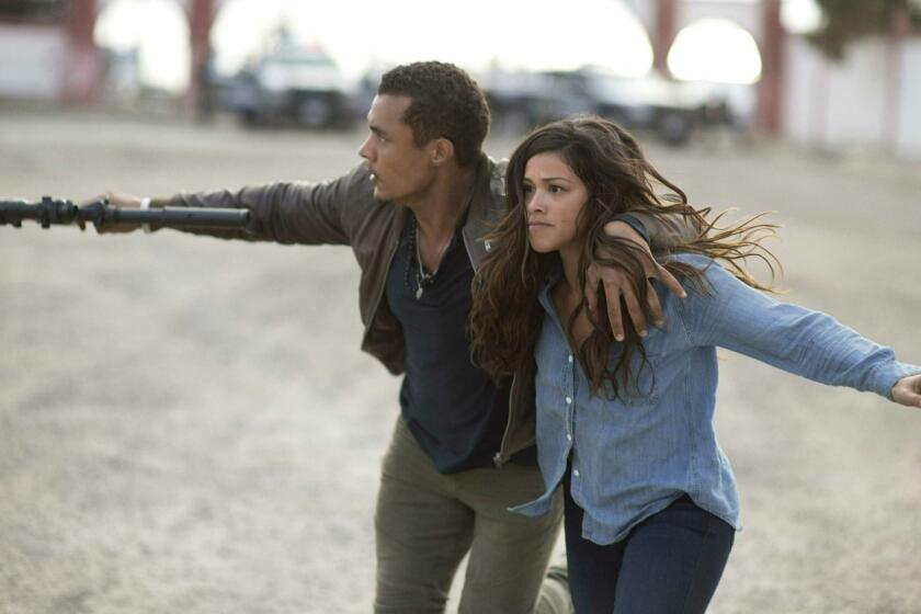This image released by Sony Pictures shows Ismael Cruz, left, and Gina Rodríguez in a scene from "Miss Bala." (Gregory Smith/Sony Pictures via AP)
