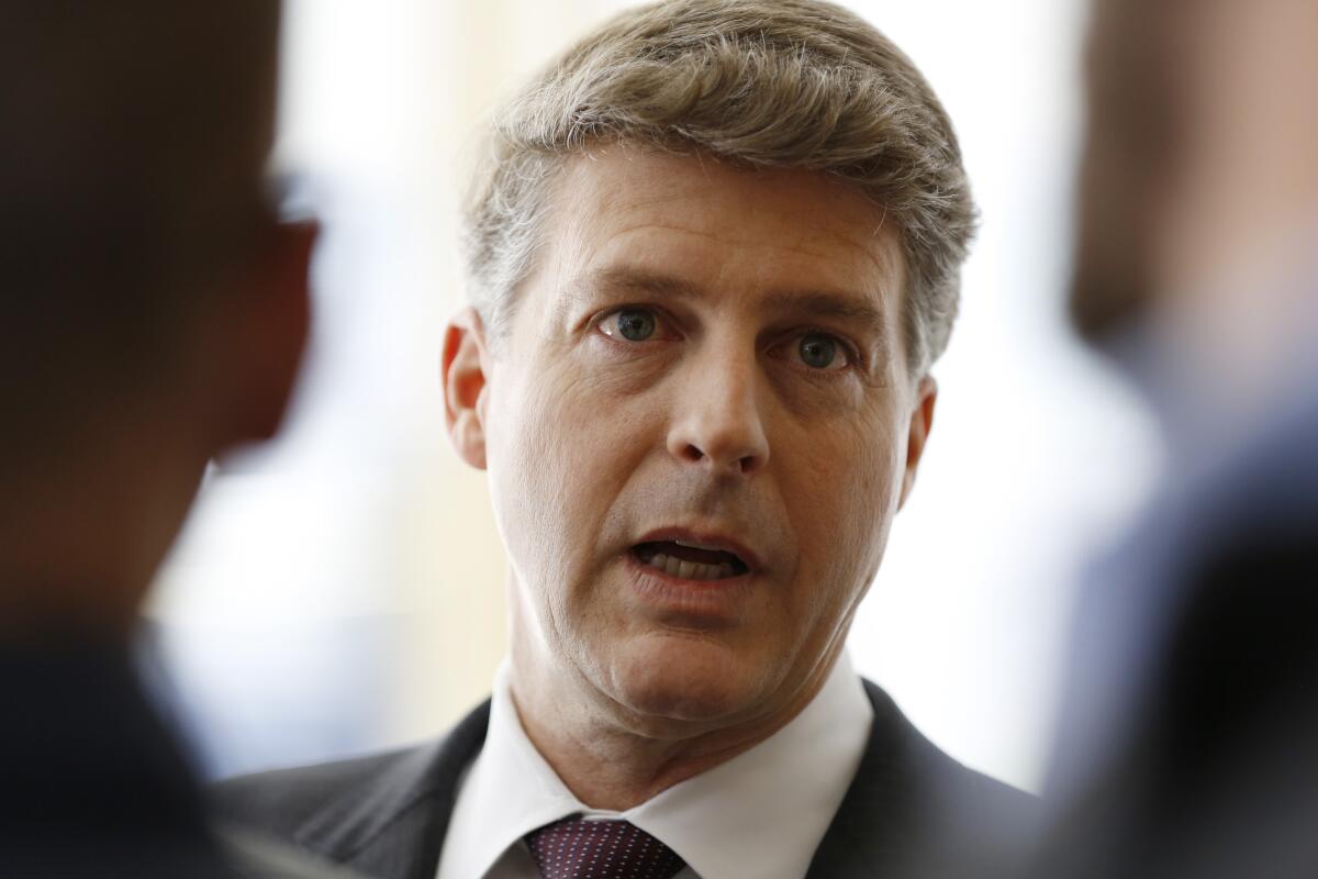 FILE - New York Yankees owner Hal Steinbrenner stops to talk to the media before attending a meeting of Major League Baseball's executive committee on May 18, 2016, in New York. Steinbrenner realizes there is a chance the price may be going up to sign Aaron Judge to a long-term contract after the star slugger’s outstanding first half. Judge turned down an eight-year contract worth $230.5 million to $234.5 million, cutting off talks ahead of the April 8 opener and saying he wouldn’t negotiate again until after the season. (AP Photo/Kathy Willens, File)