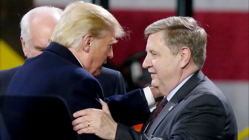 President Trump greets House candidate Rick Saccone after speaking at H&K Equipment Co. near Pittsburgh on Jan. 18