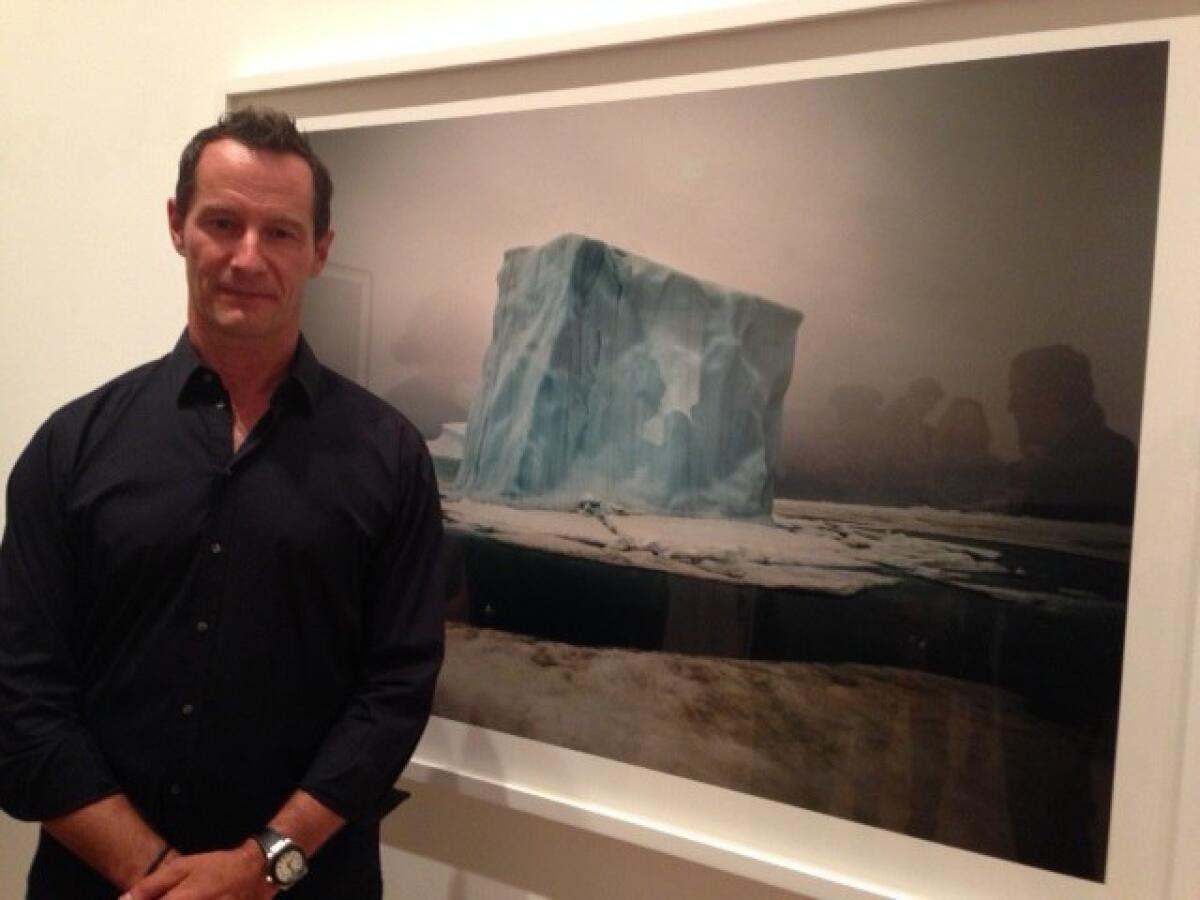 Sebastian Copeland poses in front of one of his North Pole photographs.