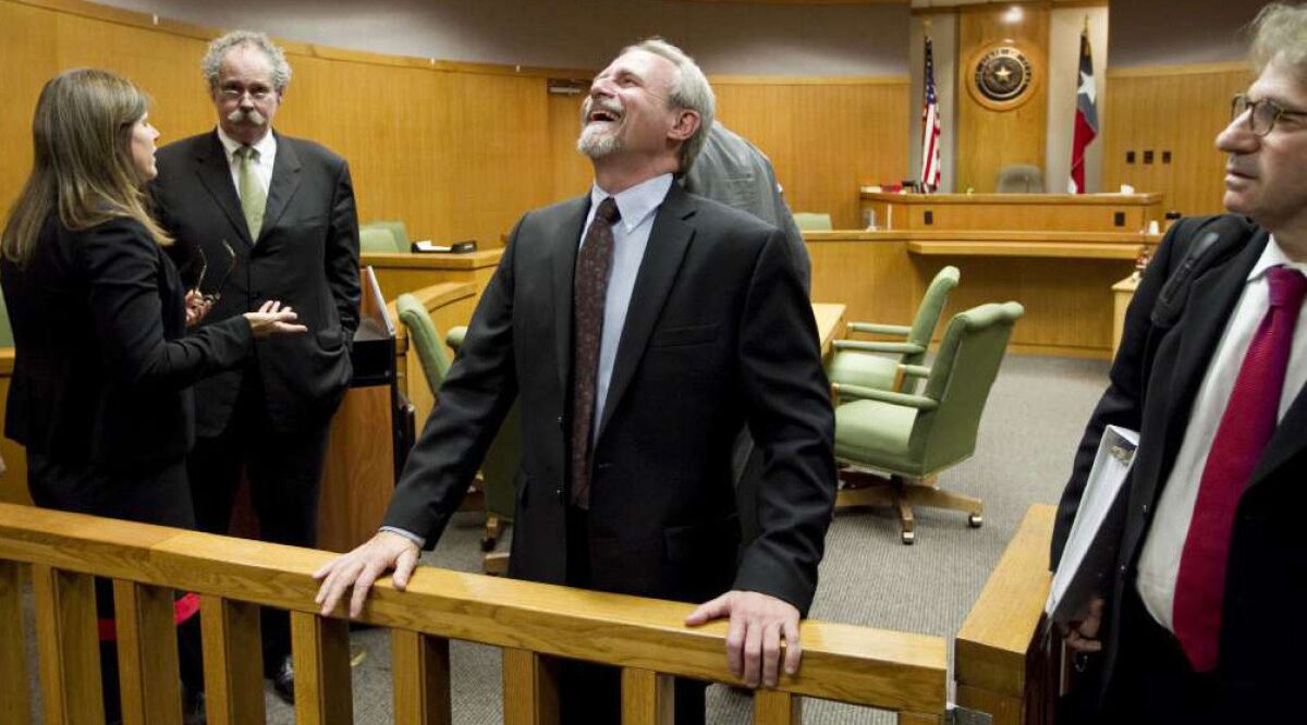Michael Morton had reason to smile a year ago after Judge Sid Harle ruled in favor of a court of inquiry for Judge Ken Anderson at the Williamson County Justice Center in Georgetown, Texas. At right is Morton's attorney Barry Scheck. Second from left is Morton's original trial lawyer Bill Allison.