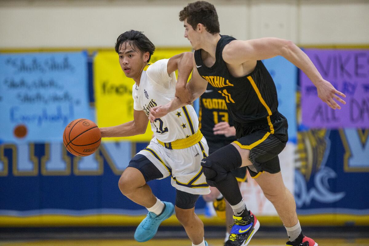 Marina's Kylle Magdangal moves the ball up court under pressure from Foothill's Aidan Roman on Tuesday.