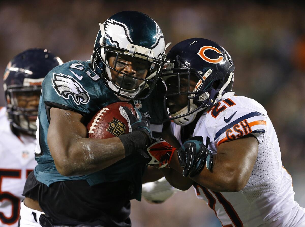Philadelphia Eagles running back LeSean McCoy, left, is grabbed by Chicago Bears safety Major Wright in a Sunday night game carried by NBC. The Eagles won, 54-11.