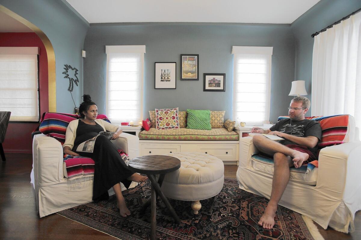 Vipula and Daniel Cunningham relax in their new den, which was converted from a dining room.