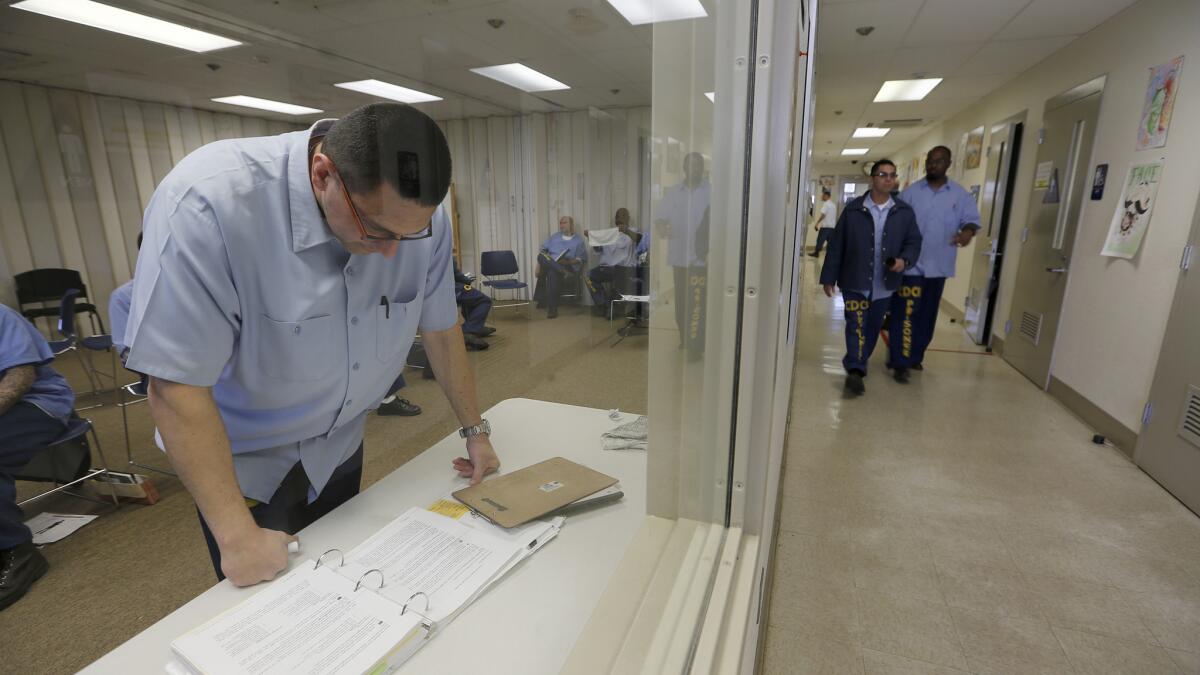 Inmate mentor Daniel Hopper prepares his notes for the Offender Mentor Certification Program class at Solano State Prison in March 2017.