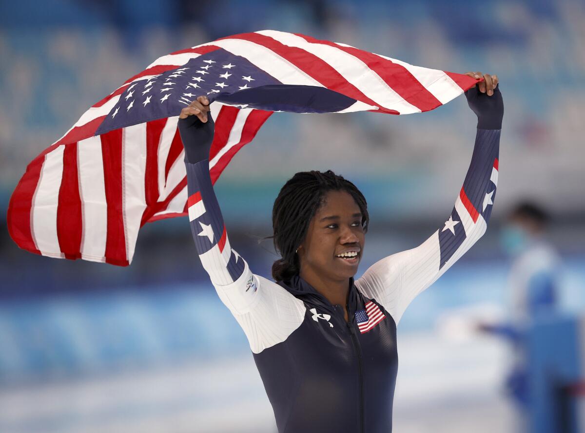 Speedskater Erin Jackson takes a victory lap with an American flag 
