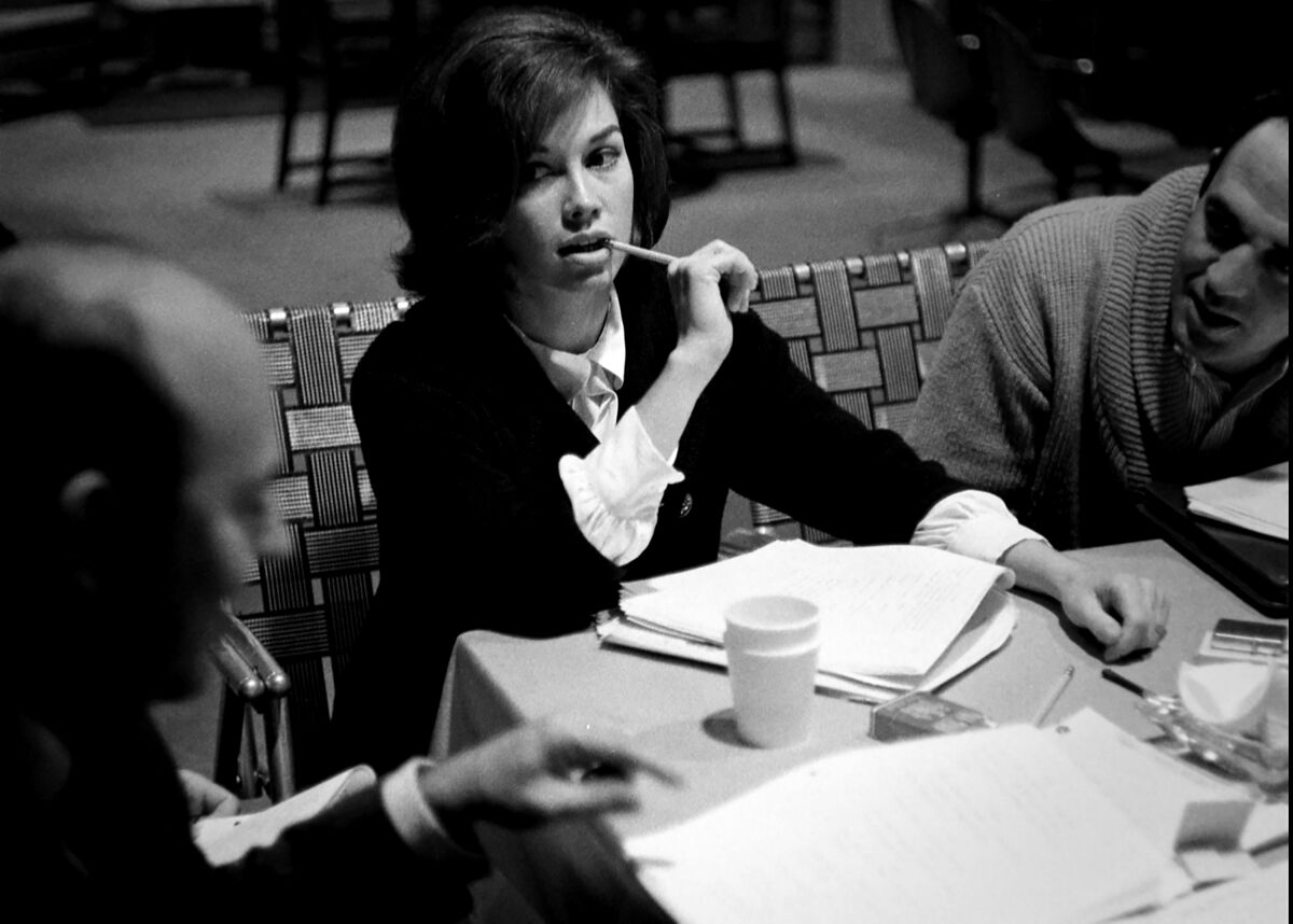 Black and white photo from "Being Mary Tyler Moore" of a young Mary Tyler Moore at a table read 