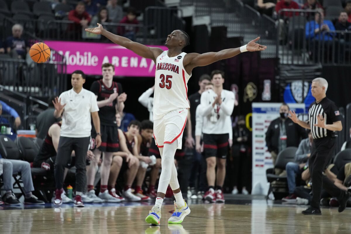 Arizona's Christian Koloko (35) celebrates after a play against Stanford during the second half of an NCAA college basketball game in the quarterfinal round of the Pac-12 tournament Thursday, March 10, 2022, in Las Vegas. (AP Photo/John Locher)