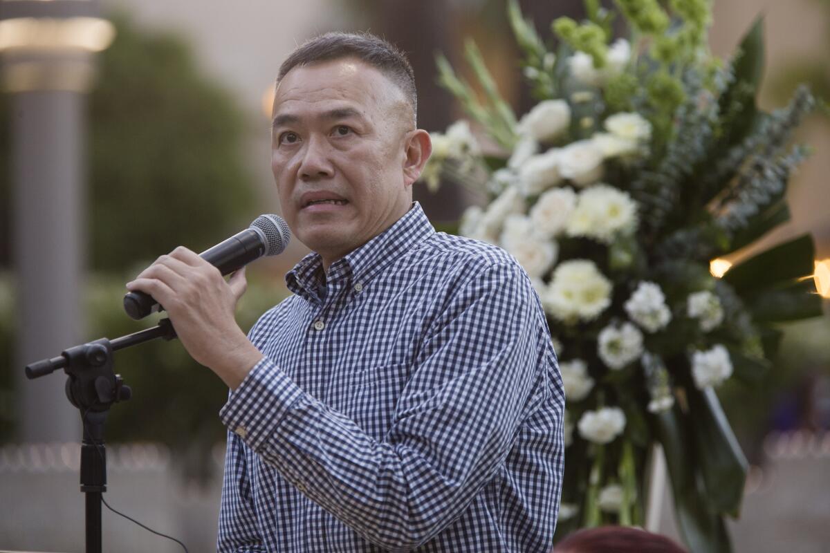 Dr. Clayton Chau speaks during a public candlelight memorial.