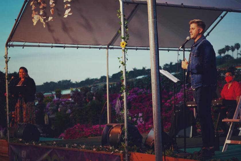Singers Jasmine January, left, and Zackary Scot Wolfe sing at the Flower Fields in Carlsbad