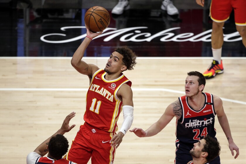 Atlanta Hawks guard Trae Young (11) puts up a shot against the Washington Wizards during the first half of an NBA basketball game Wednesday, May 12, 2021, in Atlanta. (AP Photo/Butch Dill)