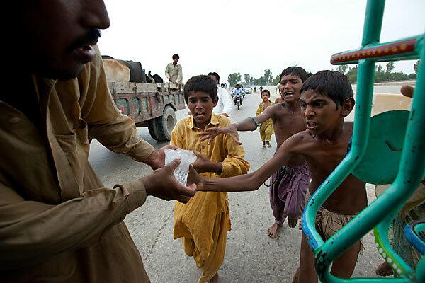 Young flood victims scramble for ice donated by a local Muslim organization in Sukkur, Pakistan. The country's agricultural heartland has been devastated as rice, corn and wheat crops have been destroyed by the floods. Pakistani officials say as many as 20 million people have been affected.