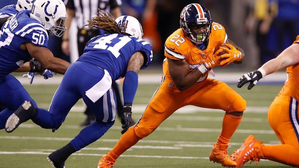 Denver Broncos' C.J. Anderson (22) runs with the ball against the Indianapolis Colts during the second half on Thursday.