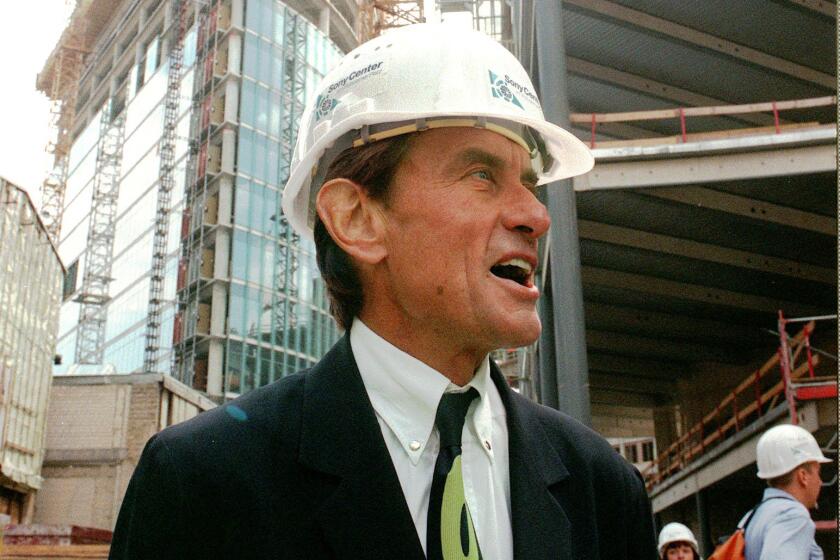 FILE - In this Wednesday, July 15, 1998 file photo, architect Helmut Jahn tours a construction site in Berlin. Jahn, 81, was killed when two vehicles struck the bicycle he was riding on Saturday afternoon, May 8, 2021, while riding north on a village street in Campton Hills, about 55 miles east of Chicago. (AP Photos/Jockel Finck)