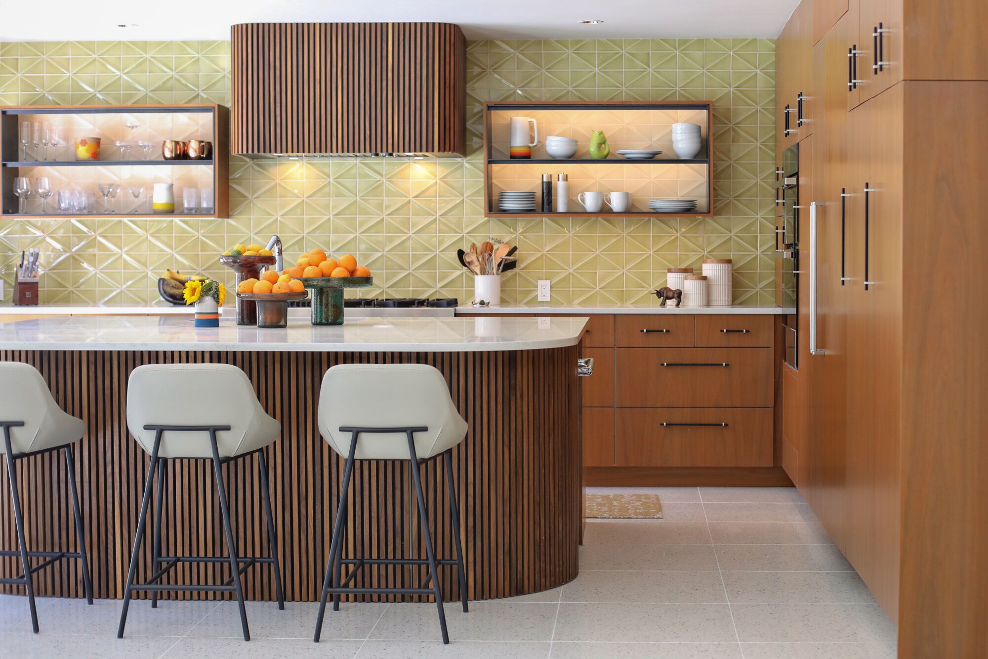 A kitchen with a green tile backsplash