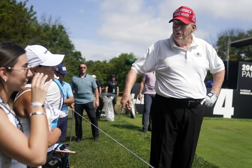 Former President Donald Trump talks to golf fans Thursday at Trump National in Bedminster, N.J.