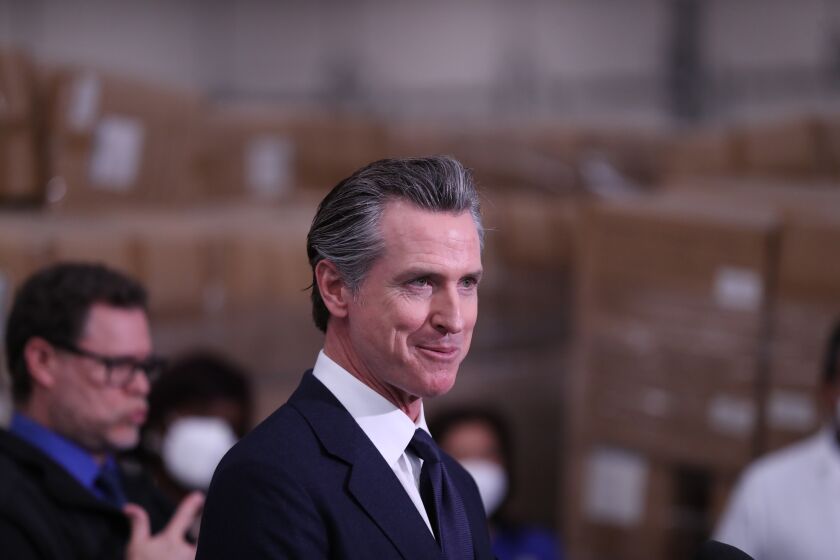 Fontana, CA - February 17: Fontana, CA - February 17: Governor Gavin Newsom speaks during a press conference to unveil the next phase of California's pandemic response in the UPS Healthcare warehouse filled with personal protective equipment in Fontana Thursday, Feb. 17, 2022. (Allen J. Schaben / Los Angeles Times)