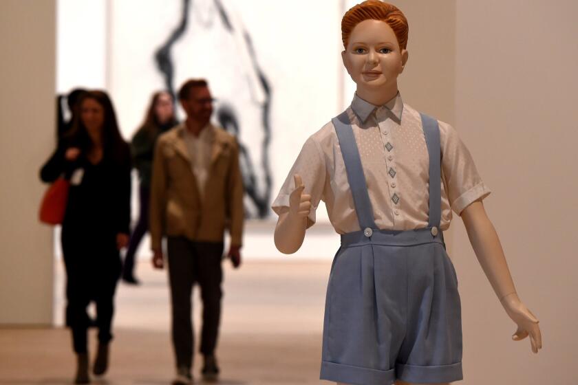 The Whitney Museum of American Art opens its new building to the public this week. "Boy," by sculptor Charles Ray, looks on as members of the media get a preview tour of the museum in advance of its opening