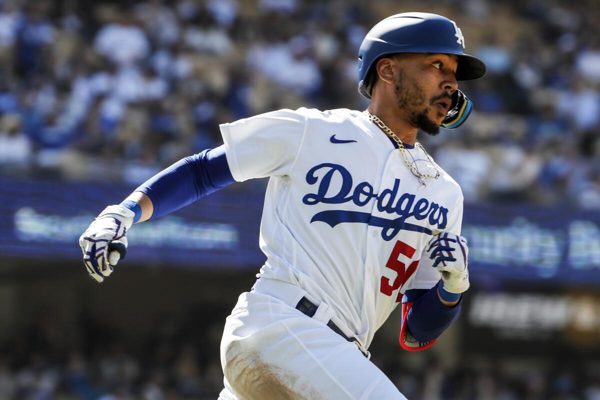 Dodgers right fielder Mookie Betts hits a ninth inning double against the San Diego Padres.