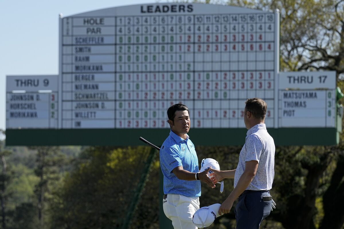 Hideki Matsuyama, of Japan, shakes hands with Justin Thomas, right, on the 18th hole during the first round at the Masters golf tournament on Thursday, April 7, 2022, in Augusta, Ga. (AP Photo/Robert F. Bukaty)