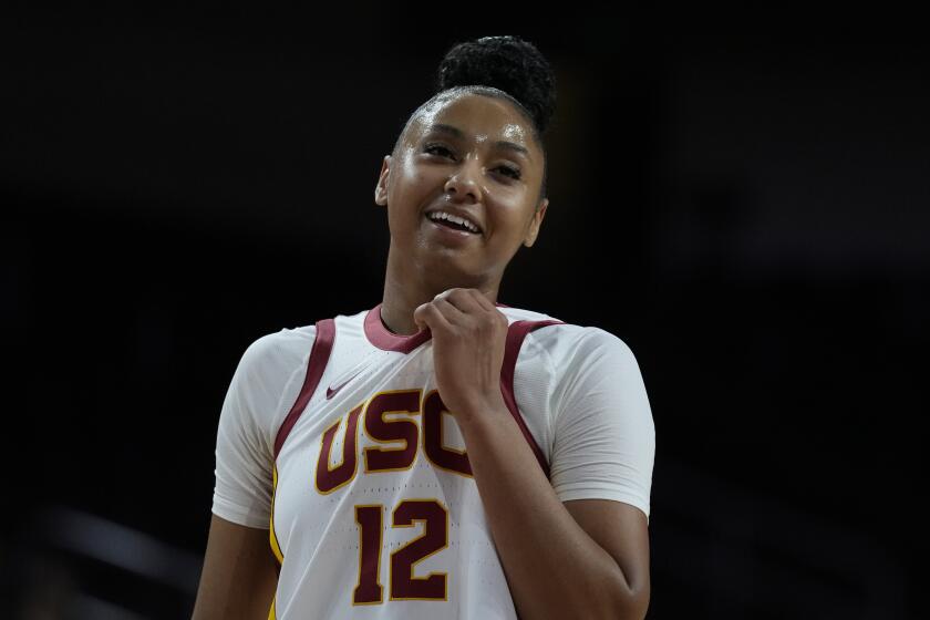 Southern California guard JuJu Watkins smiles from the court during the first half.