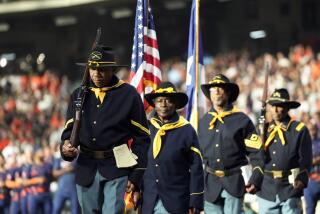 Members of the Buffalo Soldiers color guard present the colors as part of Juneteenth celebrations before a baseball game between the New York Mets and Houston Astros, Monday, June 19, 2023, in Houston. (AP Photo/David J. Phillip)