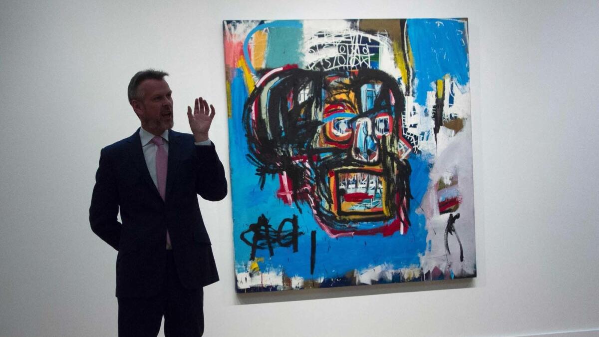 A Sotheby's official talks about Jean-Michel Basquiat's 1982 "Untitled" on May 5, 2017.
