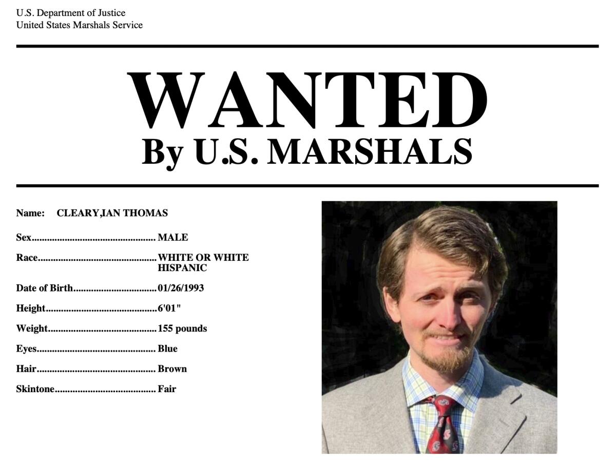  A "Wanted by U.S. Marshals" poster shows a man in a tan suit.  