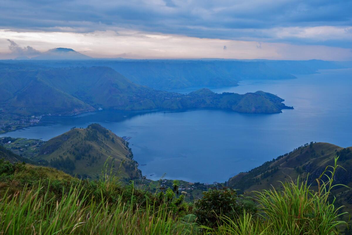 Lake Toba in Indonesia was formed 75,000 years ago after a violent volcanic eruption. It's now home to a large Christian minority, which is resisting plans to transform the region into a major Muslim tourist destination.