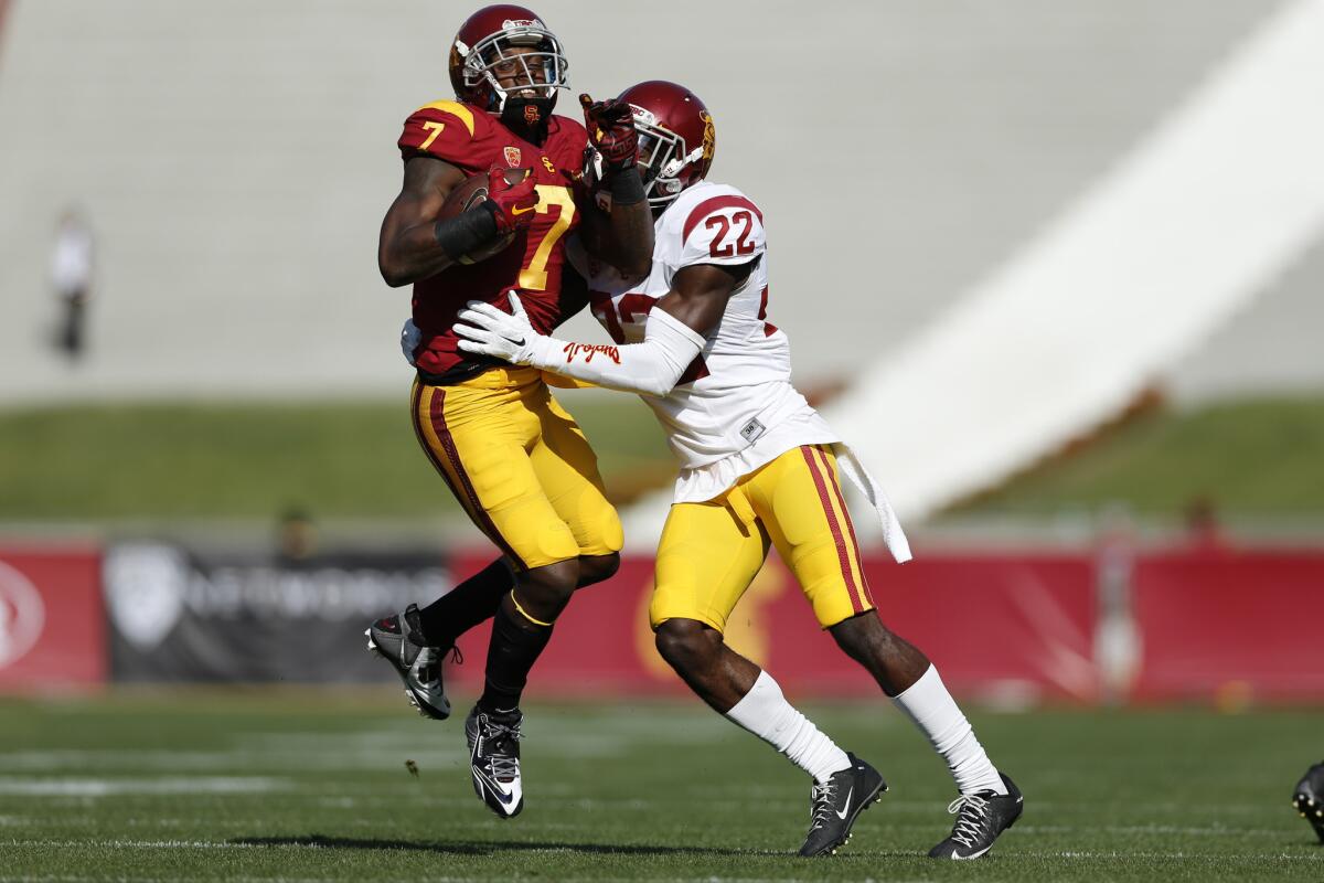 USC receiver Steven Mitchell (7), making a catch against Trojans safety Leon McQuay (22) during the annual spring game, could be the wild card this season in the team's passing game.