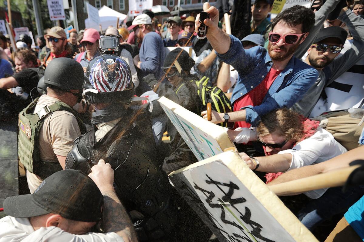 White nationalists and neo-Nazis clash with counter-protesters during a second day of violence in Charlottesville, Va., on Saturday.