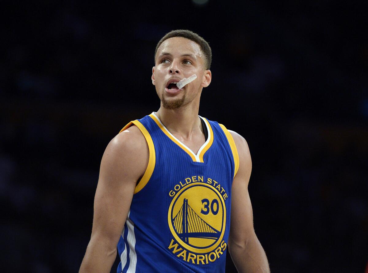 Warriors guard Stephen Curry reacts as he looks at the scoreboard at the end of the first quarter of a game against the Lakers on March 6 at Staples Center.