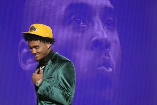 Jalen Hood-Schifino reacts as he walks off the stage after being selected 16th overall by the Los Angeles Lakers during the NBA basketball draft, Thursday, June 22, 2023, in New York. (AP Photo/John Minchillo)