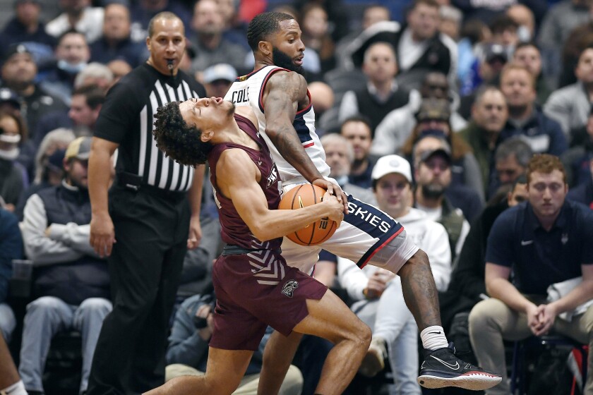 Connecticut's R.J. Cole, right, fouls Maryland-Eastern Shore's Dom London during the first half of an NCAA college basketball game, Tuesday, Nov. 30, 2021, in Hartford, Conn. (AP Photo/Jessica Hill)