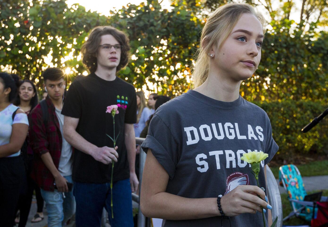 Students were greeted by supporters, signs and flowers as they returned to class at Marjory Stoneman Douglas High School on Wednesday.