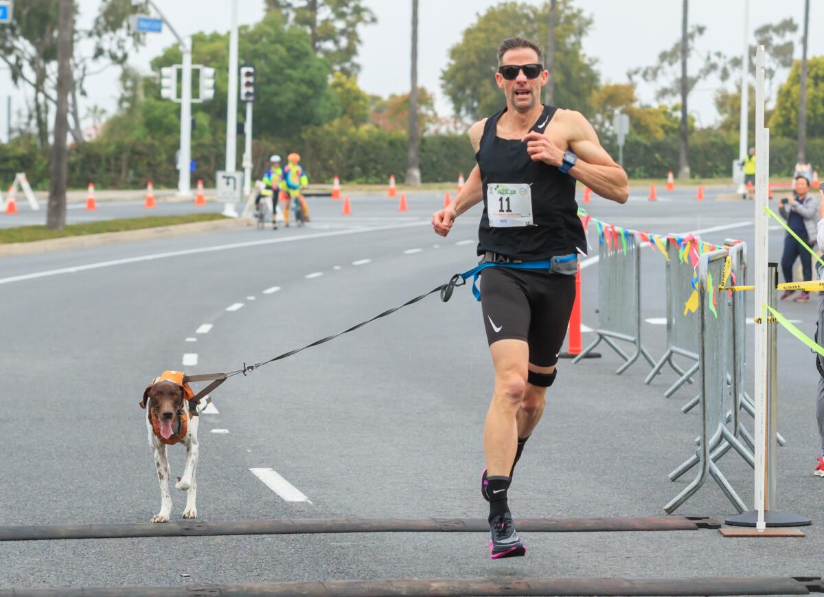 In the male-dog mile last year, runner Brian Duff and his dog Axl.