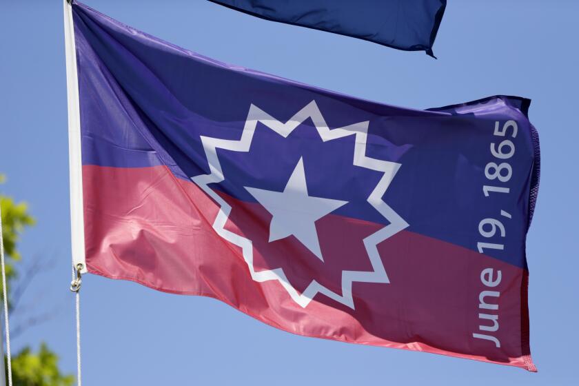 The Juneteenth flag, commemorating the day that slavery ended in the U.S., flies in Omaha, Neb., Wednesday, June 17, 2020. (AP Photo/Nati Harnik)