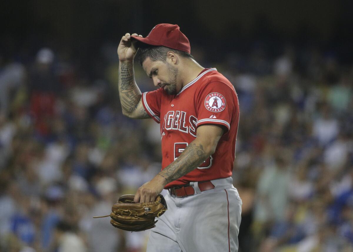 Angels starting pitcher Hector Santiago walks off the field after the fifth inning. He took the loss against the Dodgers after allowing five runs.