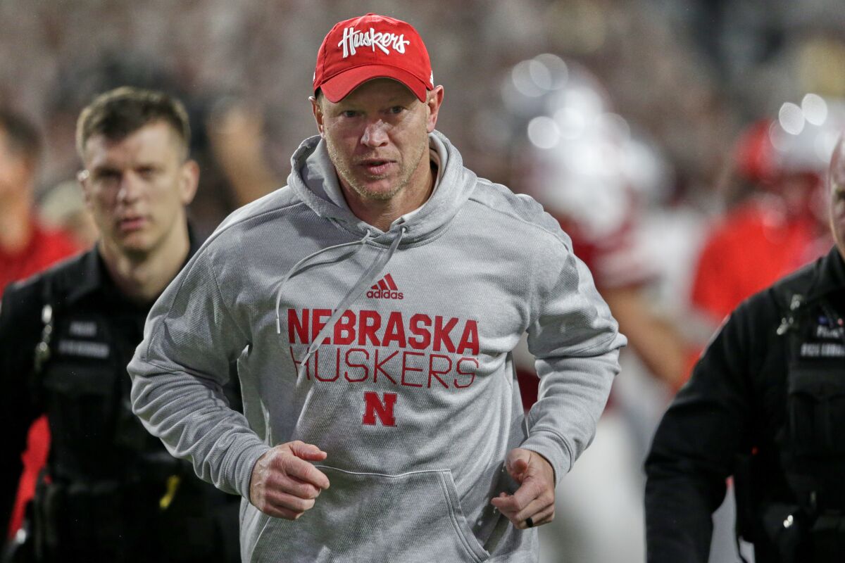 Nebraska coach Scott Frost runs to the locker room following a game