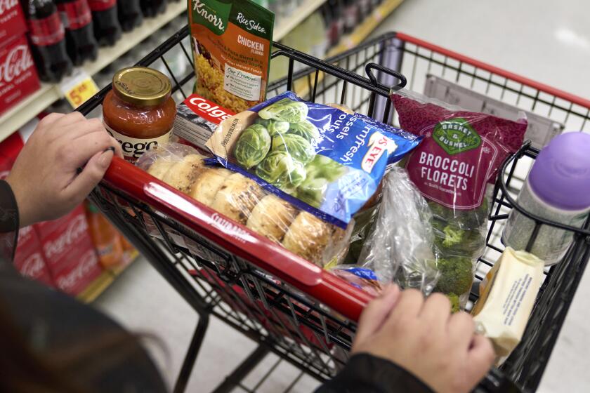 Jaqueline Benitez, who depends on California's SNAP benefits to help pay for food, shops for groceries at a supermarket in Bellflower, Calif., on Monday, Feb. 13, 2023. Nearly 30 million Americans who got extra government help with grocery bills during the pandemic will soon see that aid shrink. (AP Photo/Allison Dinner)