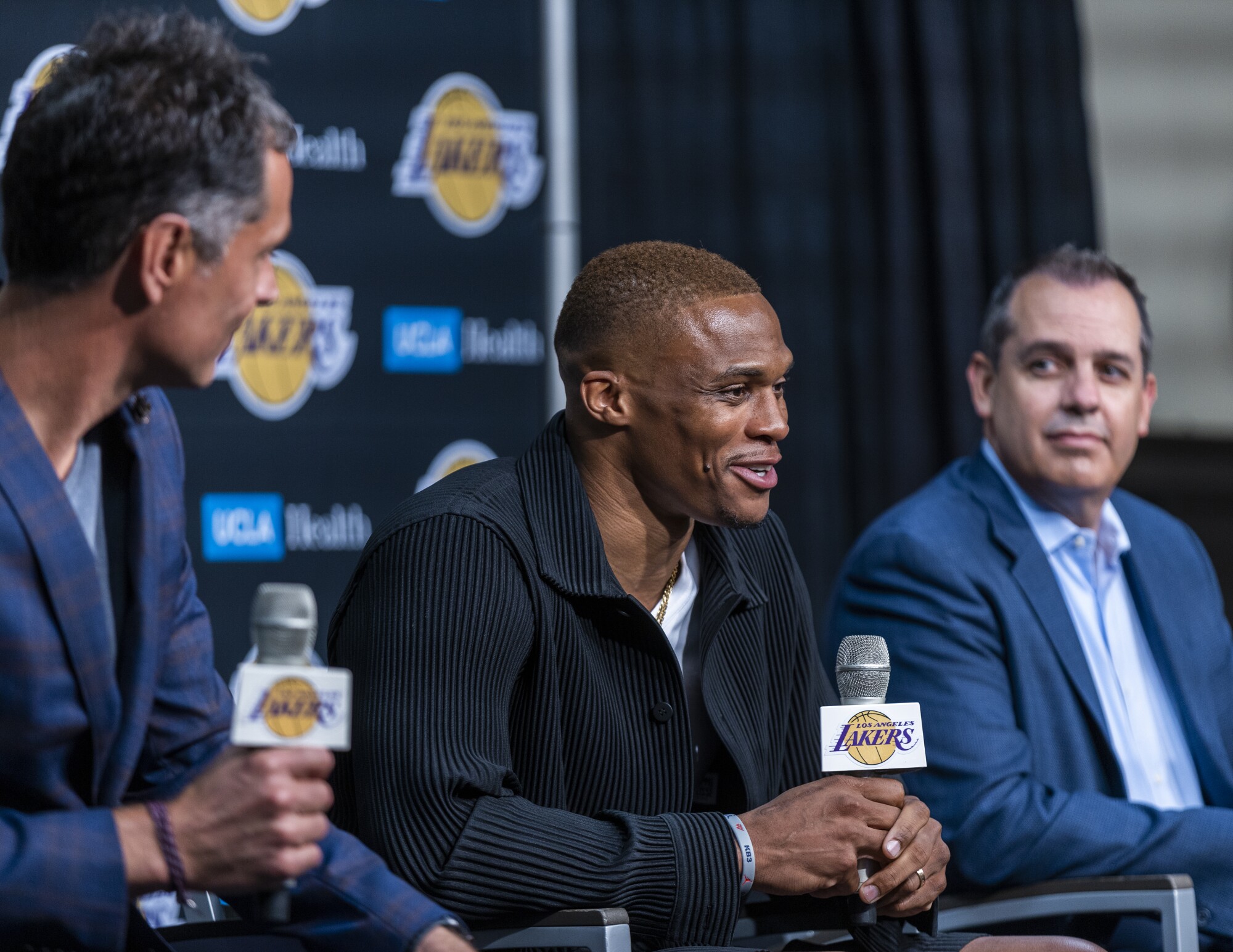 Russell Westbrook, center, is flanked by Lakers GM Rob Pelinka, left, and coach Frank Vogel while addressing the media.