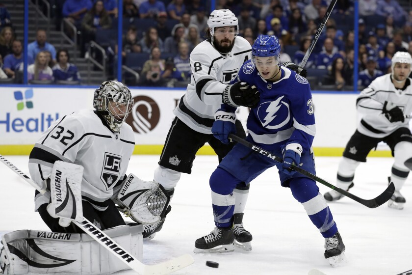 Kings defenseman Drew Doughty (8) keeps Tampa Bay Lightning center Yanni Gourde (37) from a rebound after a shot on goaltender Jonathan Quick (32) during the second period on Tuesday in Tampa, Fla.