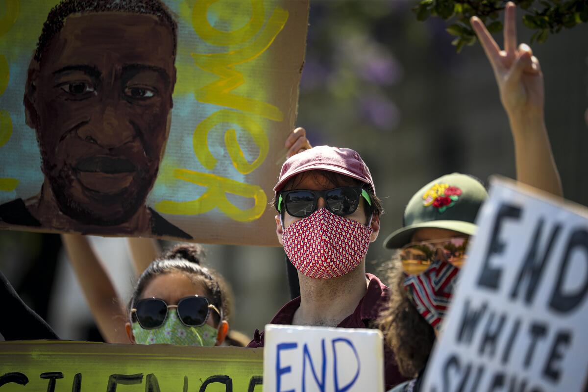 Alan Michnoff, center, protests the death of George Floyd in front of the North Hollywood police station.