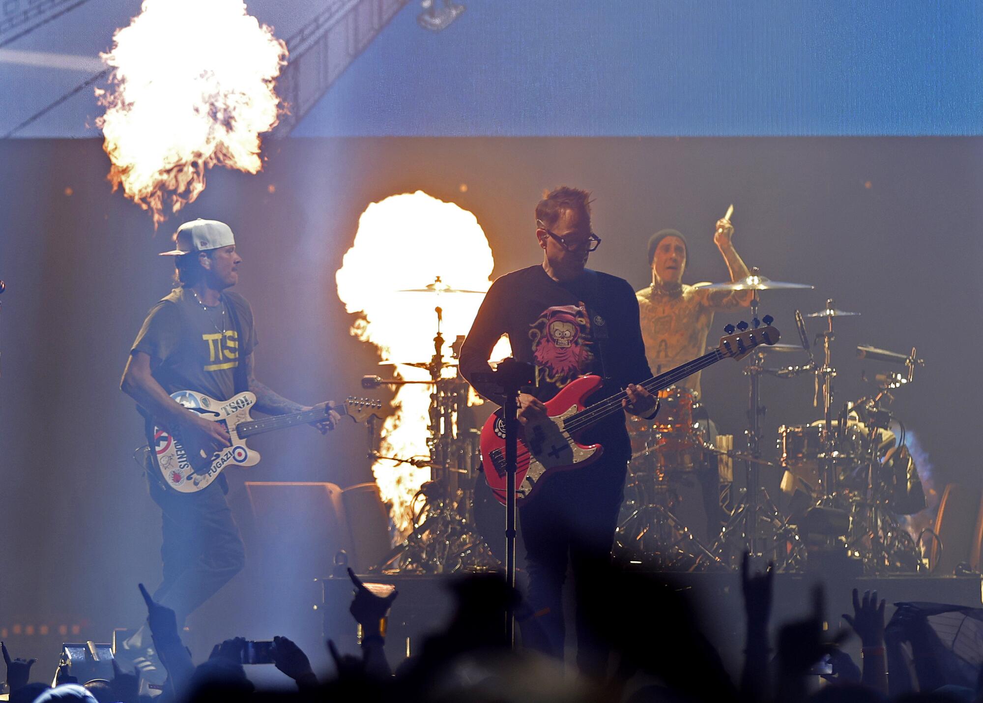 Tom DeLonge, left, Mark Hoppus and Travis Barker of blink-182 perform in San Diego on Monday.