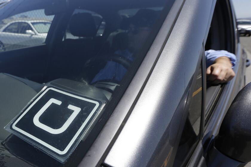 An Uber driver parked near the San Francisco International Airport in July.